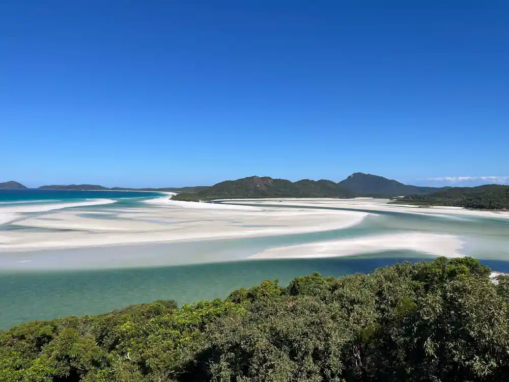 Aerial view of turquoise lagoon with white sand and green islands