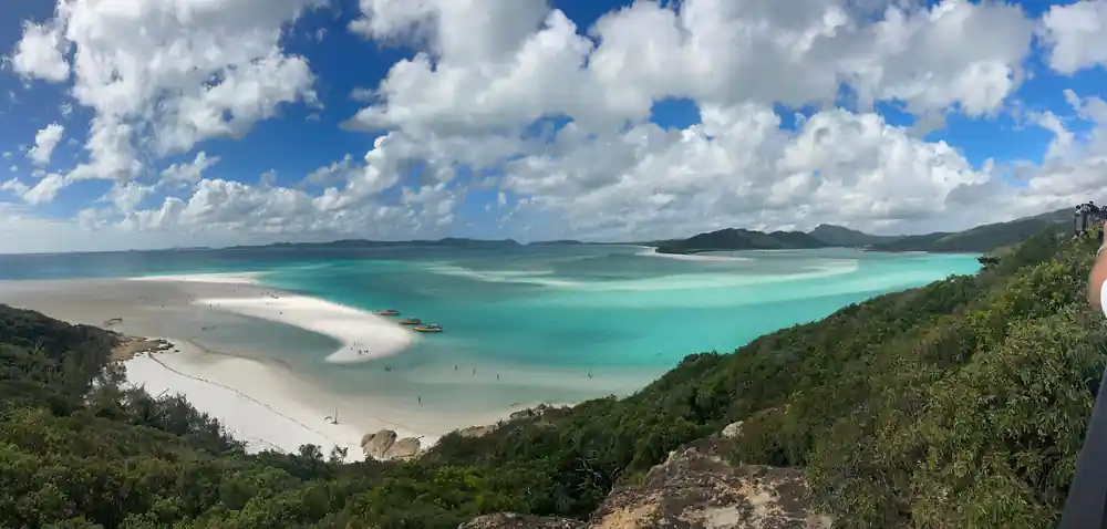 Elevated view of curved white beach and turquoise lagoon