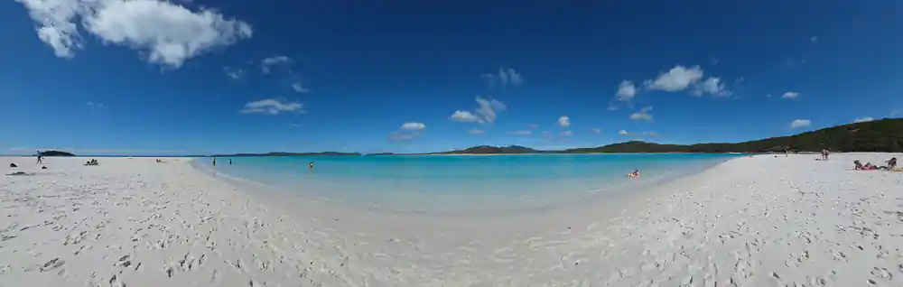Wide sandy beach with calm turquoise water